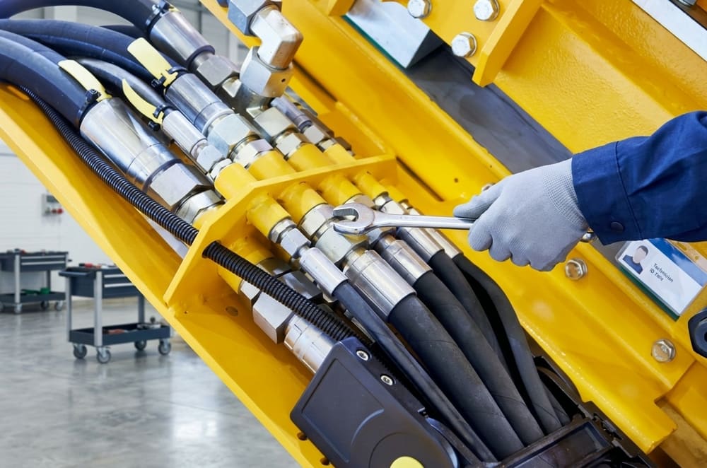 Manutenção de mangueiras hidráulicas em uma máquina pesada